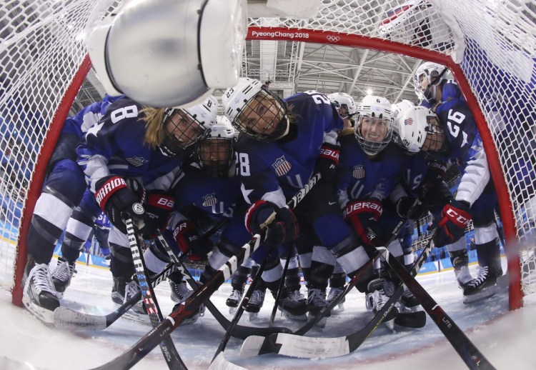 Players from the United States pose fas they gather around the goal before their women's hockey game against the team from Russia at the 2018 Winter Olympics on Tuesday. ()
