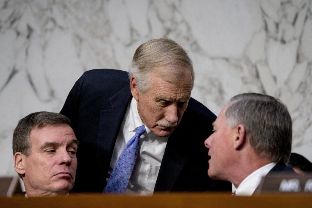 From left, Vice Chairman Mark Warner, D-Va., Sen. Angus King, I-Maine, and Chairman Richard Burr, R-N.C., speak together during a Senate Select Committee on Intelligence hearing on worldwide threats on Tuesday in Washington.