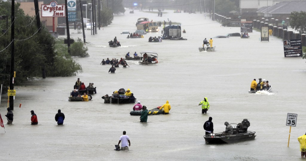 Rescue boats ferry Houston residents to higher ground during Hurricane Harvey last year. A new study suggests the sea level could be rising faster than scientists believed, and could worsen the impact of coastal storms, like Harvey.
