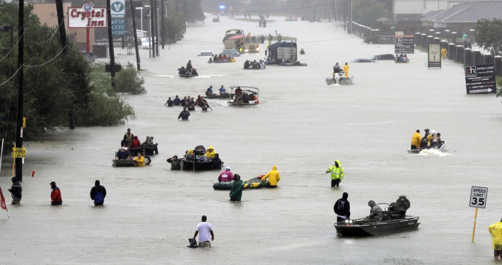 Rescue boats ferry Houston residents to higher ground during Hurricane Harvey last year. A new study suggests the sea level could be rising faster than scientists believed, and could worsen the impact of coastal storms, like Harvey.