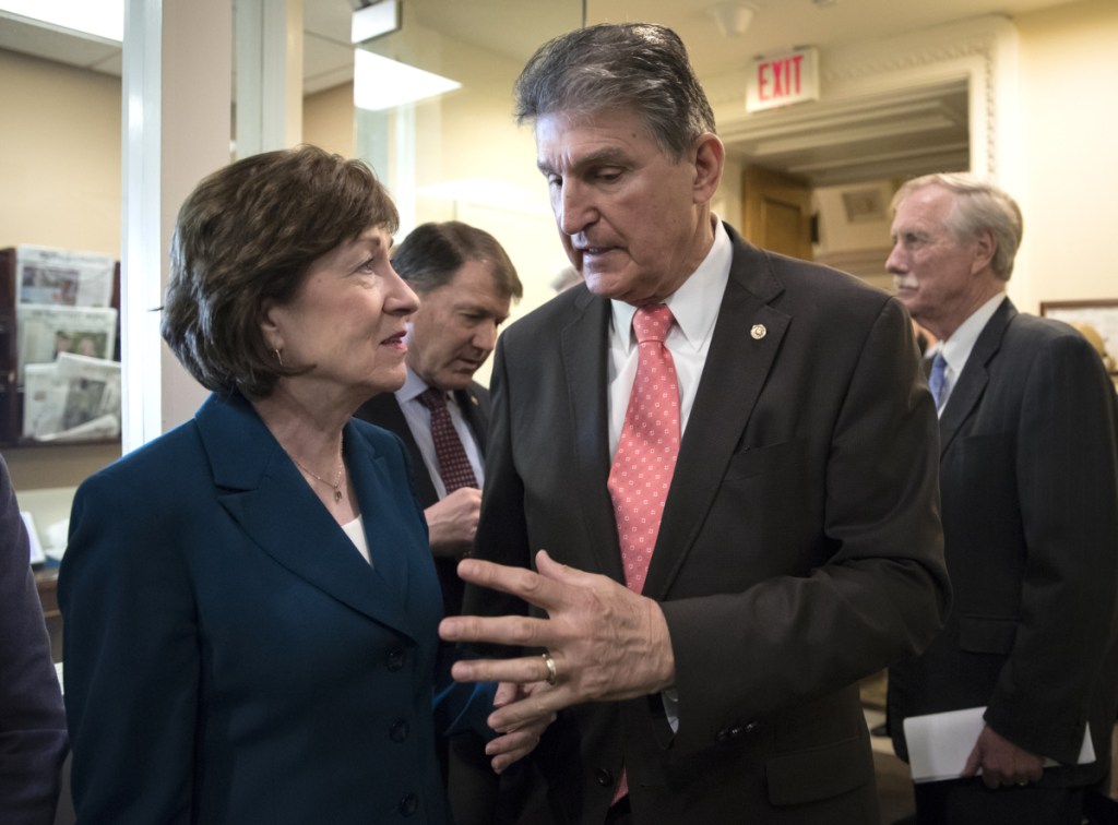 Sens. Susan Collins, R-Maine, and Joe Manchin, D-W.Va., joined at right by independent Maine Sen. Angus King, confer at the Capitol before a news conference to discuss the bipartisan immigration deal, which later failed to advance in the Senate.
Associated Press/J. Scott Applewhite