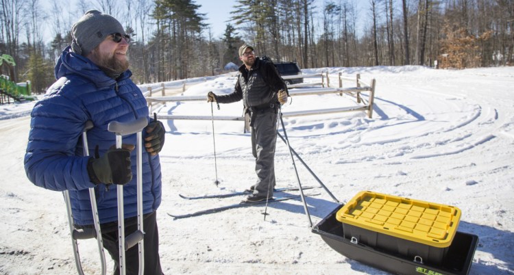 Jeff Anderson, left, and Stephen Bailey, who are avid winter campers, show off one of the homemade camping sleds that they designed for their trips.