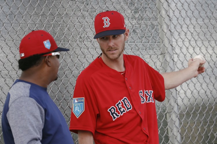 Boston Red Sox starting pitcher Chris Sale, right, speaks with former Red Sox hall of fame pitcher Pedro Martinez during baseball spring training Wednesday in Fort Myers, Fla.