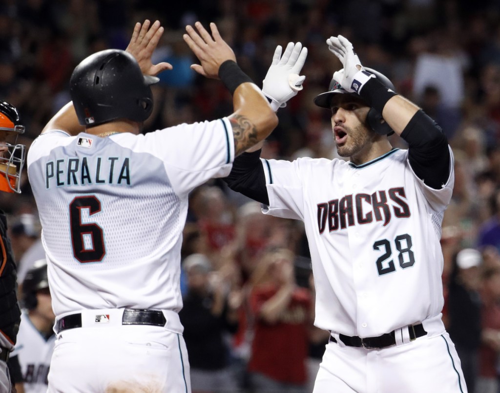 J.D. Martinez, right, who hit 45 home runs and drove in 104 runs last season, has agreed to a five-year, $110-million deal with the Red Sox, according to a source.