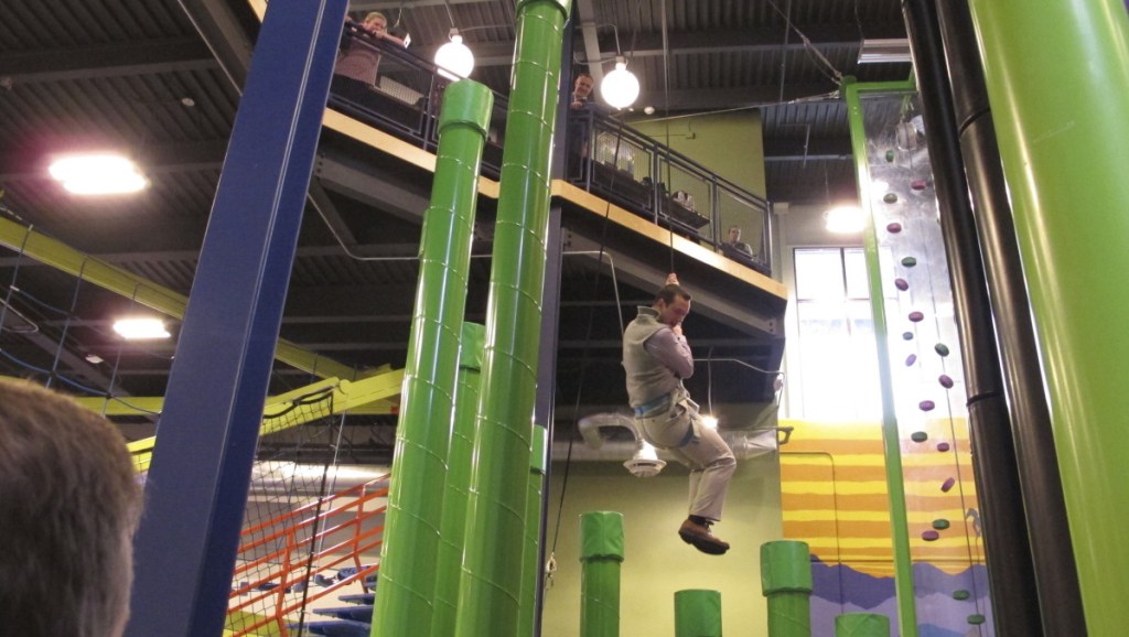 Jason Maulucci of the Vermont governor's office tries a new indoor climbing facility at Jay Peak ski area. Resorts in the region offer other activities, such as water parks, swimming or laser tag, for use when ski conditions are poor.