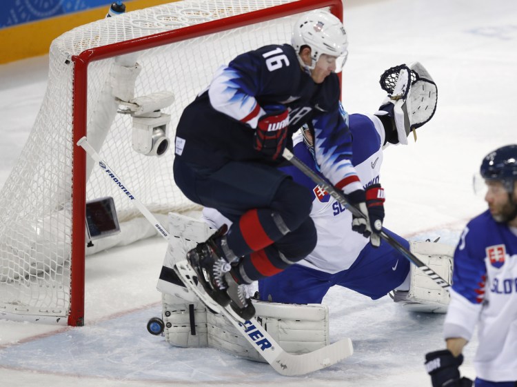 Ryan Donato jumps to let the puck shot by James Wisniewski through for a goal during the second period against Slovakia at the 2018 Winter Olympics in South Korea on Tuesday.