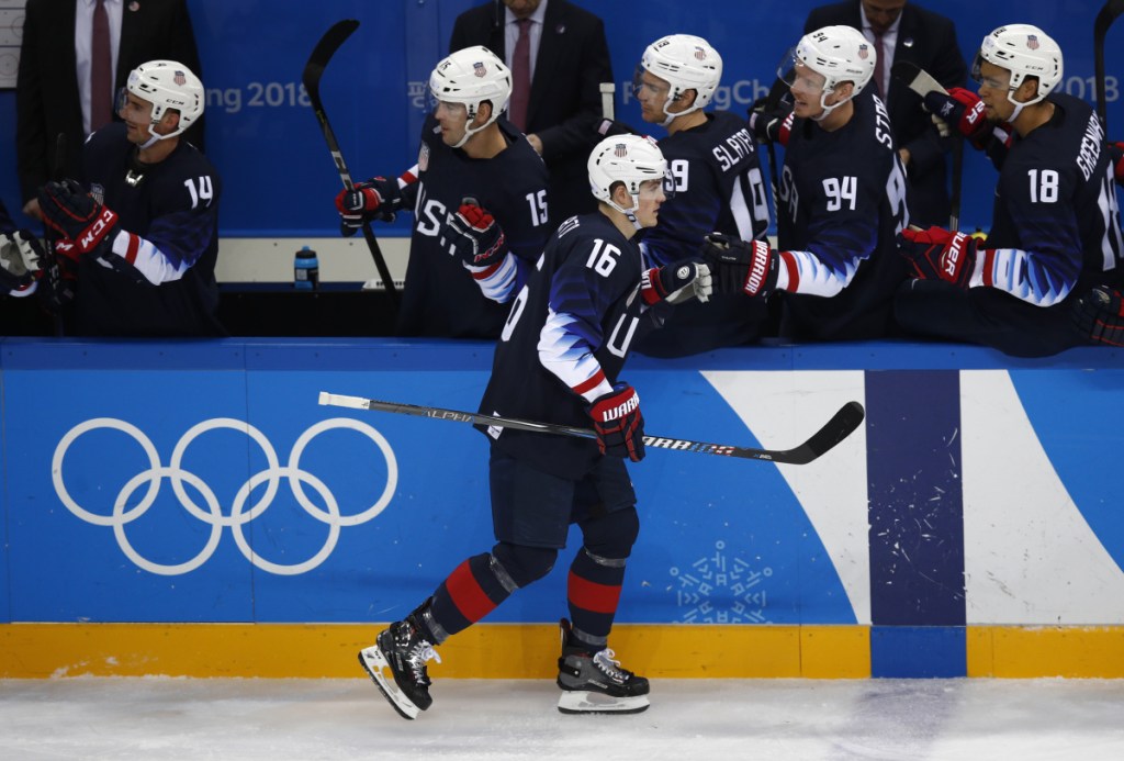 Ryan Donato high fives his teammates after scoring a goal against Slovakia.