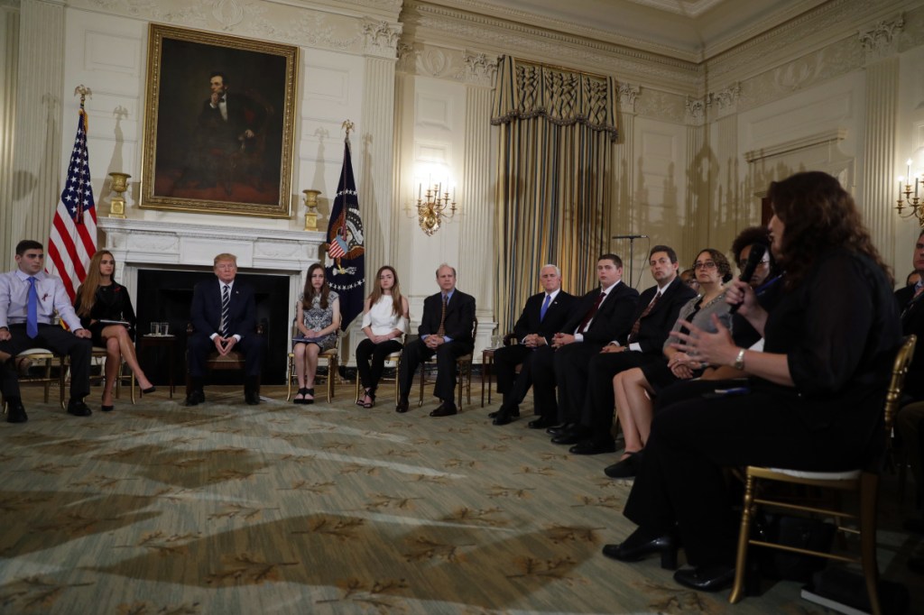 President Trump listens to the Mayor of Parkland, Fla., Christine Hunschofsky, right, speak as he meets with high school students, parents and teachers who have been affected by school shootings, in the State Dining Room of the White House in Washington in February.