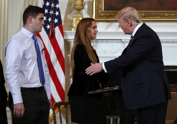 President Trump greets Julia Cordover, the student body president at Marjory Stoneman Douglas High School in Parkland, Fla., at a listening session with high school students and teachers in February at the White House. Behind Cordover is fellow student Jonathan Blank.