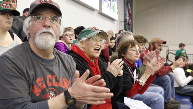 Stephen Lerman, Cindy Lerman and Pam Barker, left to right, don't just cheer for the Maine Red Claws, but do eveything they can to make sure the players feel at home during their time in Portland.