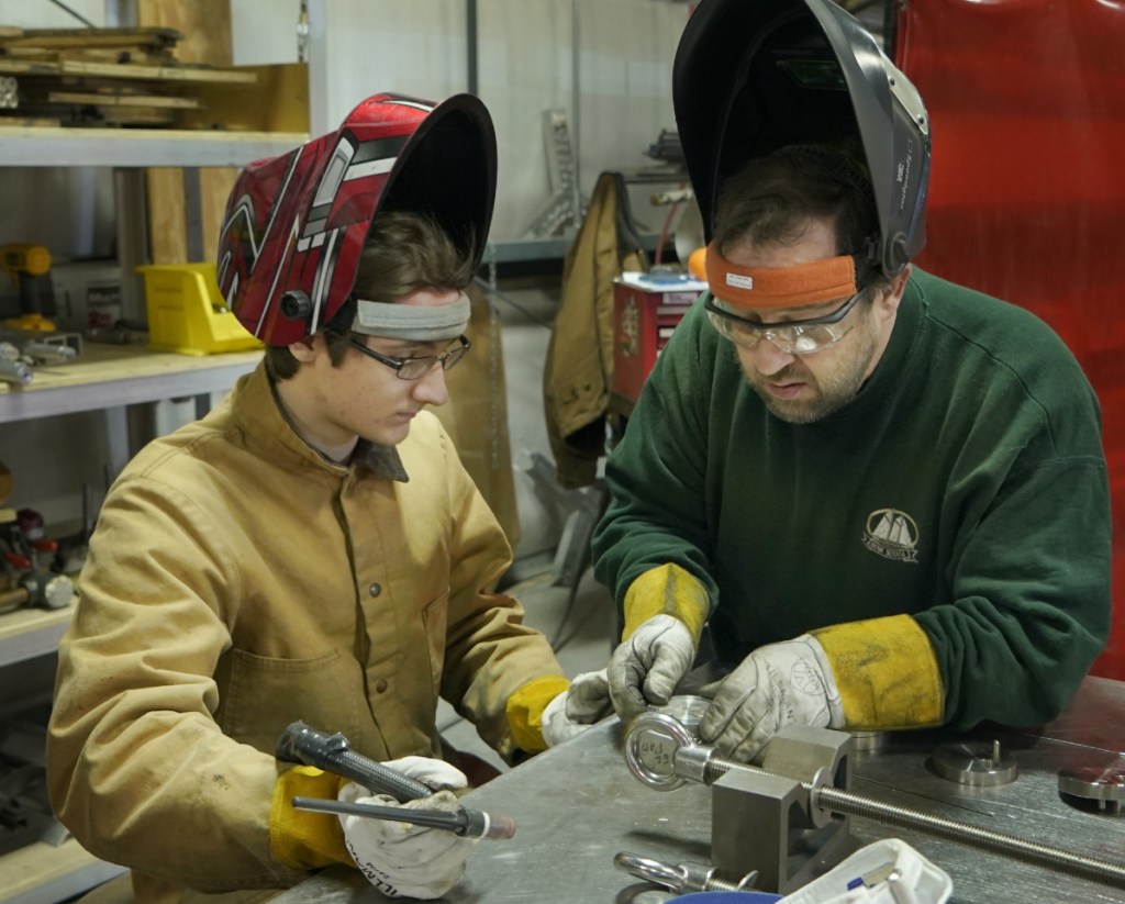 Sam Roy, left, and Joe Woods prepare parts to be welded at DeepWater Buoyancy. Co-owner Matthew Henry said welders are in short supply. "The best thing we can do for him is show him all the skills he'll need beyond welding," Henry said.