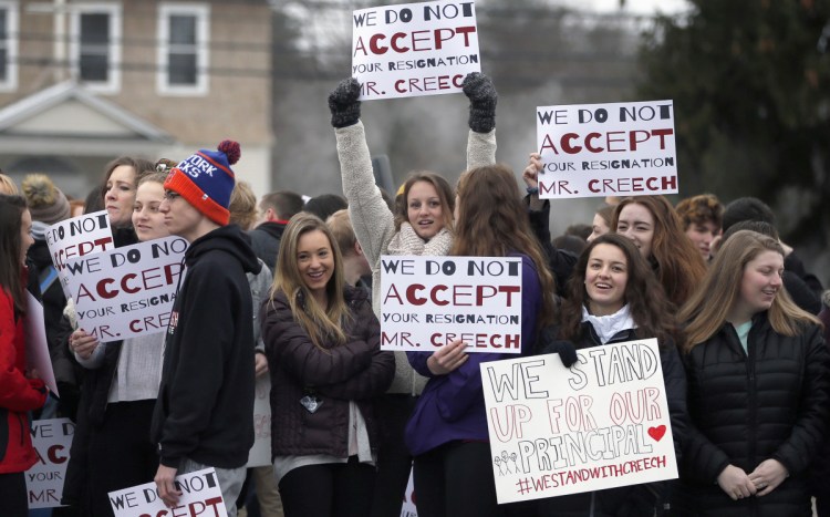 Scarborough High School students hold placards during a rally in February in support of Principal David Creech, who resigned amid controversy over school start times.