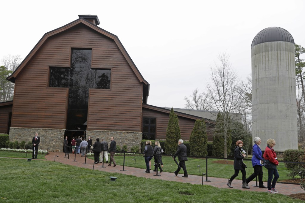 People stream through the Billy Graham Library as they come to bid farewell to Billy Graham during a public viewing in Charlotte, N.C., Monday. Former President George W. Bush and first lady Laura Bush were among them.