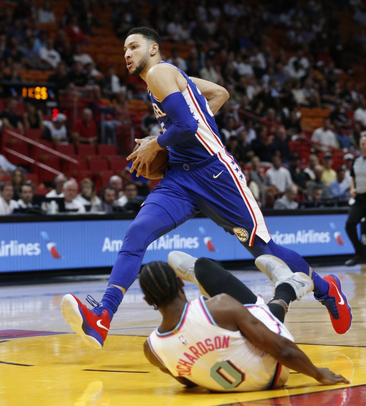 Philadelphia's Ben Simmons goes up for a shot against Miami guard Josh Richardson during the first half of their game Tuesday in Miami. The Heat won the game, 102-101.