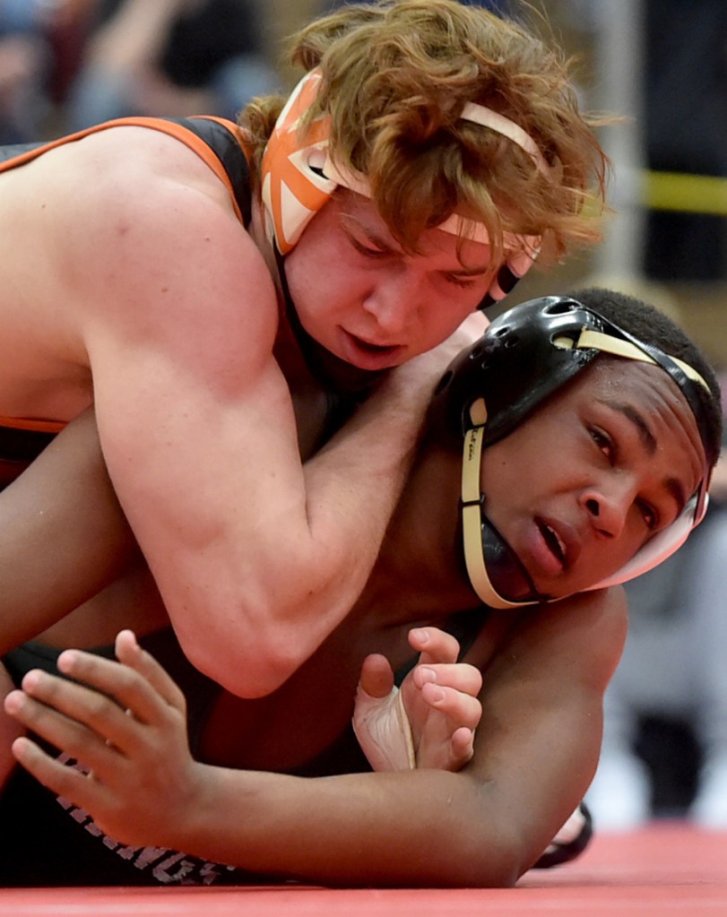 Winslow's Ryan Fredette, left, battles Oxford Hills' Zuka Mabior in the 182-pound championship bout at last season's Kennebec Valley Athletic Conference championships at Mt. Ararat High School in Topsham.