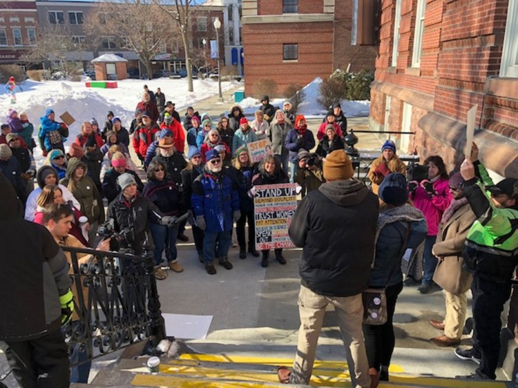 A crowd outside City Hall in Waterville listens on Saturday, Feb. 3, as John Reynolds, Minday Saint Martin's brother, speaks about U.S. Customs and Immigration Enforcement officials' seizure of his brother-in-law, Lexius Saint Martin, who arrived in the United States as a child and is expected to be deported to his native Haiti.