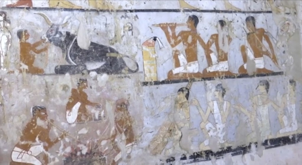 This image taken from video on Saturday, Feb. 3, shows wall paintings inside a 4,400-year-old tomb near the pyramids outside Cairo, Egypt. Egypt's Antiquities Ministry announced the discovery Saturday and said the tomb likely belonged to a high-ranking official known as Hetpet during the 5th Dynasty of ancient Egypt. The tomb includes wall paintings depicting Hetpet observing different hunting and fishing scenes.