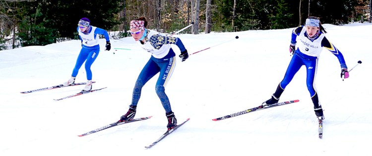 Meg Charles of Mt. Blue High School, center, leads a pair of skiers across the line during the Oxford Hills Sprints at Roberts Farm. At left is Jenny Wilkerson of Morse, and at right is Eva Clement of Falmouth.