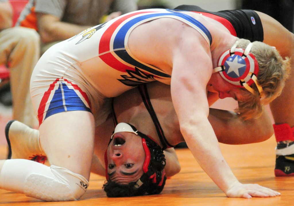 Wiscasset's Sam Strozier, bottom, and Messalonskee's Austin Pelletier compete in the consolation semifinals during the Kennebec Valley Athletic Conference championships Saturday at Cony High School in Augusta. Pelletier won.