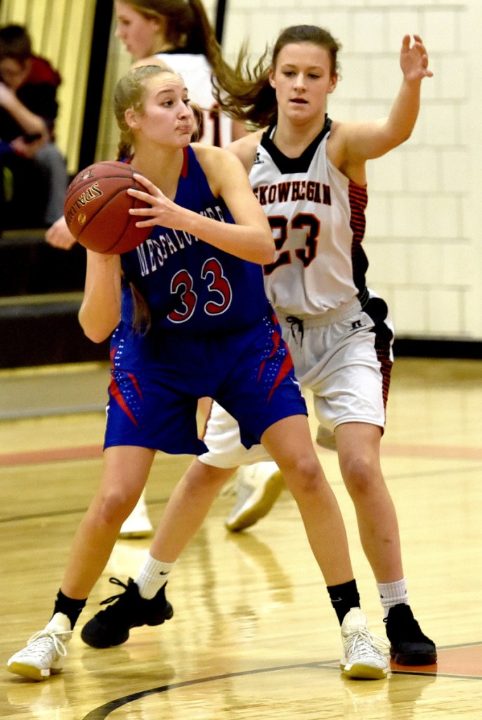 Messalonskee's Ally Turner looks to pass as Skowhegan's Alyssa Everett defends during a Kennebec Valley Athletic Conference Class A game Monday night in Skowhegan.