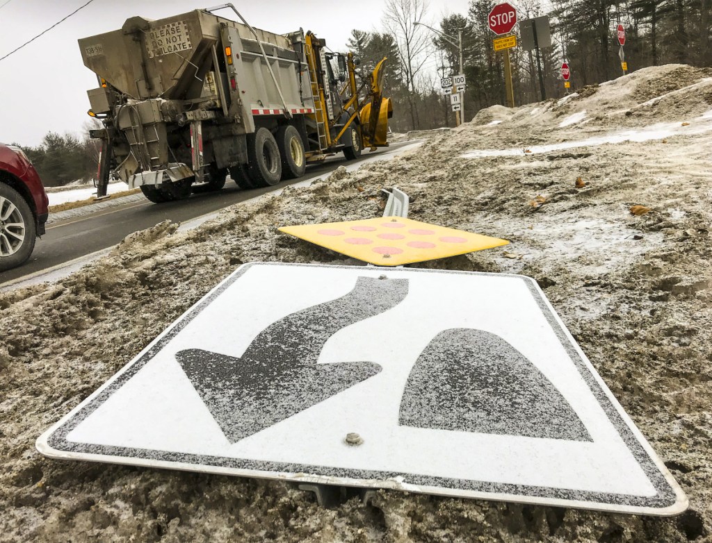 A toppled sign lies along the edge of Main Street on Tuesday in Winthrop. The sign is intended to direct drivers turning off U.S. 202 to stay to the right, but it was knocked over last week in a crash. Local police have notified the state Department of Transportation about the downed sign, while town officials are asking the department to review the area's new traffic pattern after a recent spike in crashes.