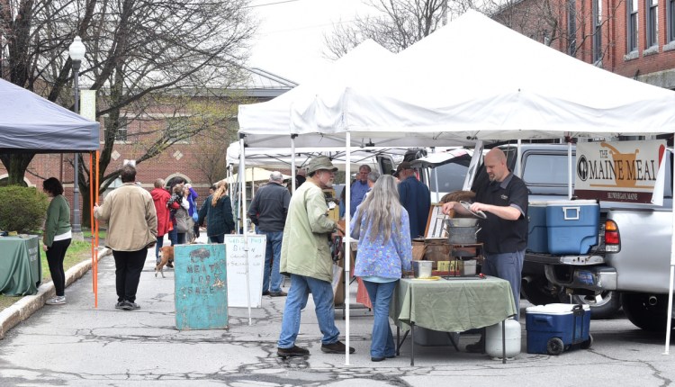 People browse among the produce April 27, 2017, at the first farmers market of the season on Common Street in Waterville.