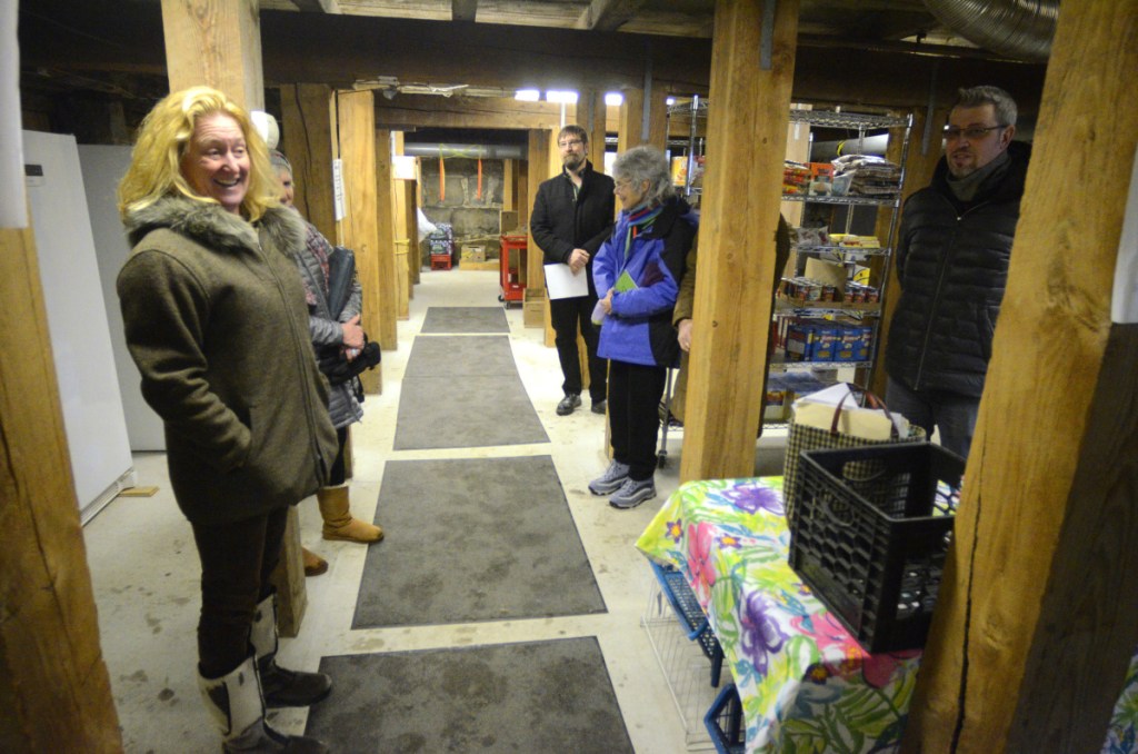 Director Jeanne Langsdorf, left, leads a tour of the Hallowell Food Bank on Thursday in the fire house basement in Hallowell.