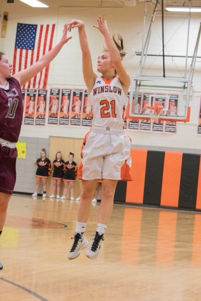 Photo by Jennifer Bechard 
 Winslow's Haley Ward launches a 3-pointer while MCI's Sydney Farrar defends during a Class B North game Thursday night in Winslow.