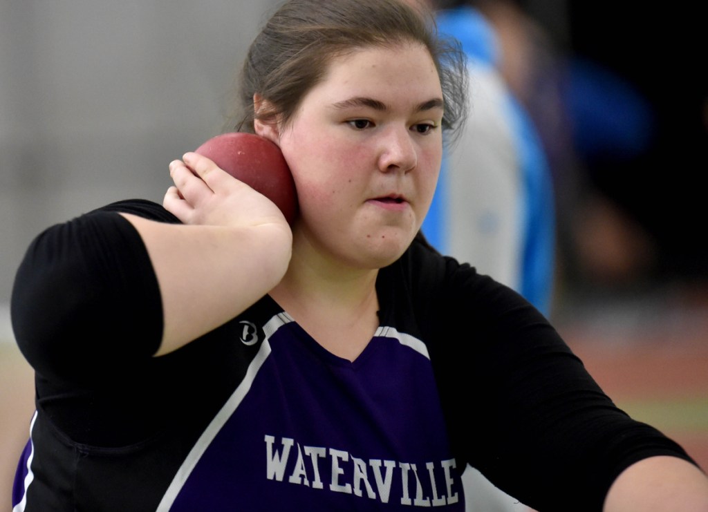 Waterville junior Sarah Cox, center, prepares to throw the shot put at a Feb. 3 Kennebec Valley Athletic Conference track and field meet at Bowdoin College in Brunswick.