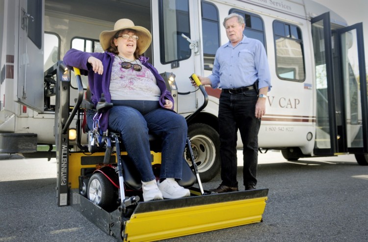 Cindy Dow is lifted into a Kennebec Valley Community Action Program bus on Oct. 15, 2013, at her Augusta home for a ride to an appointment. Augusta city officials are considering partnering with KVCAP to provide additional busing for senior citizens at housing complexes.