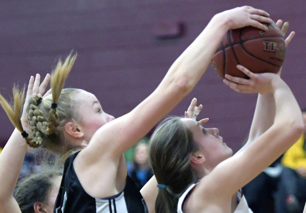RICHMOND, ME - JANUARY 13: Richmond High School's Lindsie Irish is blocked by Waynfleet's Lydia Giguere during a basketball game on Tuesday February 13, 2018 in Richmond.(Staff photo by Andy Molloy/Staff Photographer)