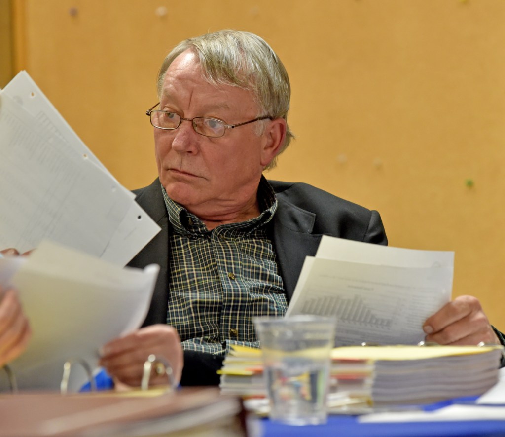 Eric Haley, superintendent of Vassalboro Community School, presented the school board Tuesday night with estimated costs for contracted services and the salary for a superintendent if one is hired. Haley is also the superintendent for Winslow and Waterville schools. Here he reads through the budget in March 2016 in the Waterville City Council chamber.