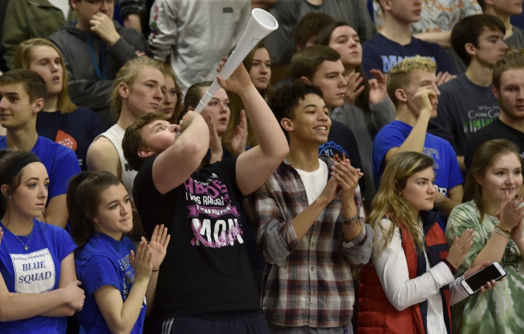 Erskine Academy students, including Derrick Dyer with horn, cheer in support of the girls basketball team, which was recognized for raising $10,000 for the American Cancer Society during a ceremony Tuesday at the South China school.
