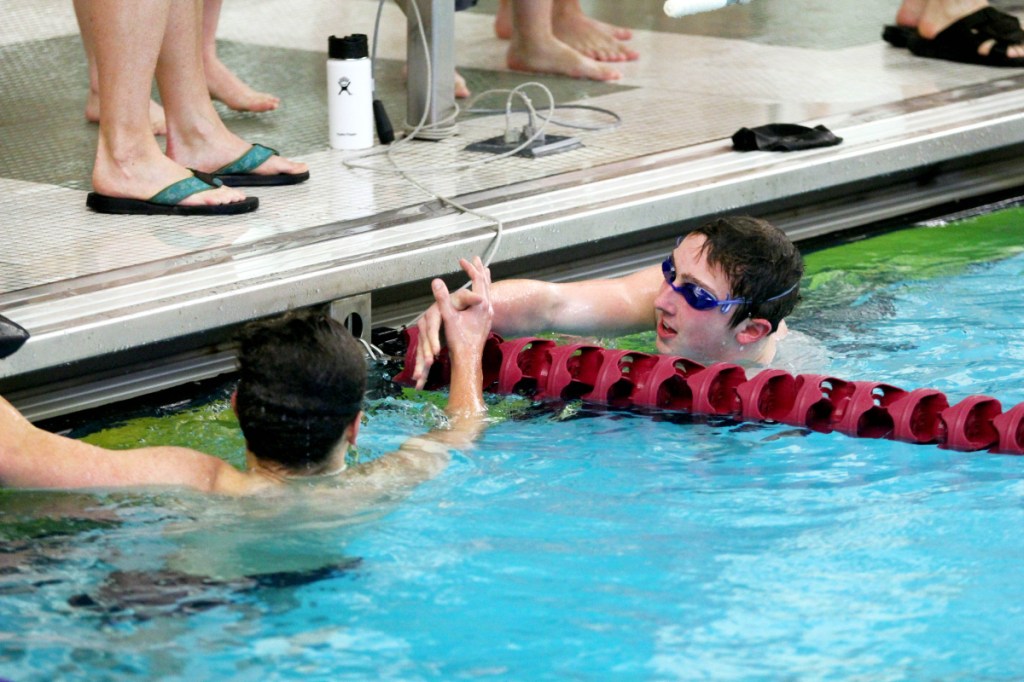 File photo by Jeff Pouland
Waterville/Winslow's John Reisert is congratulated by Mt. Ararat's Deven Hoskins after winning the 500-yard freestyle at the Kennebec Valley Athletic Conference Class A meet last season in Bath.