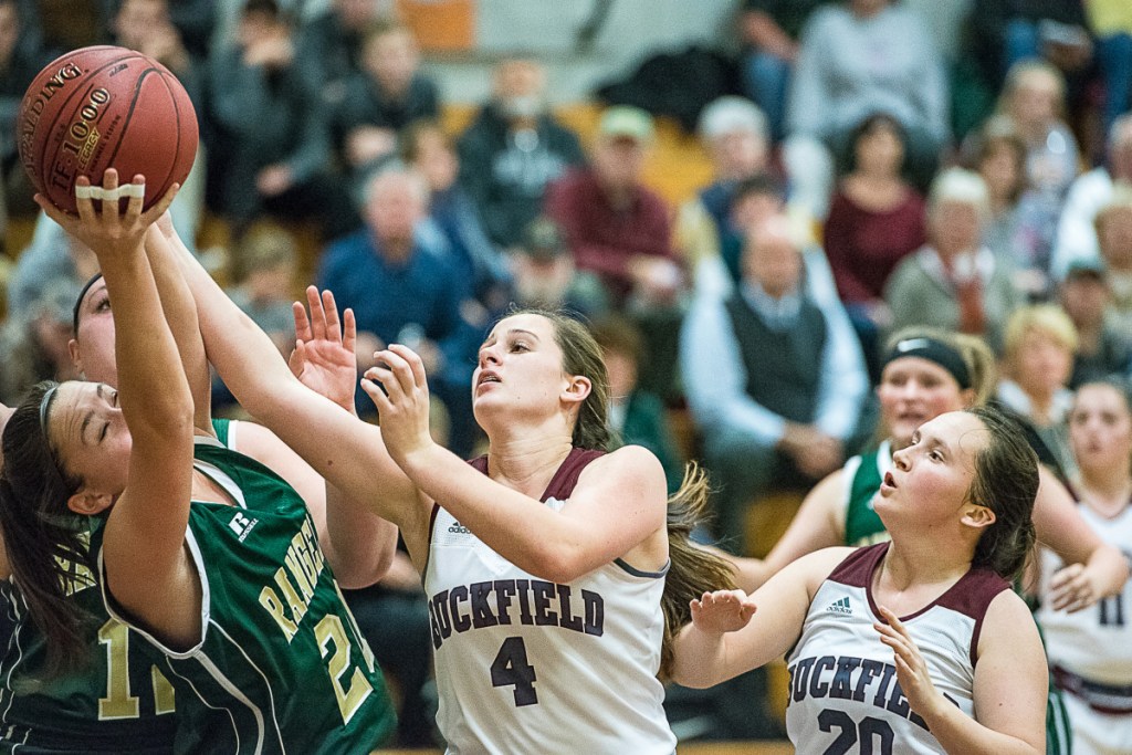 Sun Journal photo by Andree Kehn 
 Rangeley's Winnie Larochelle, left, and Buckfield's Caroline Trimm fight for a rebound during a Class D South game last month in Buckfield