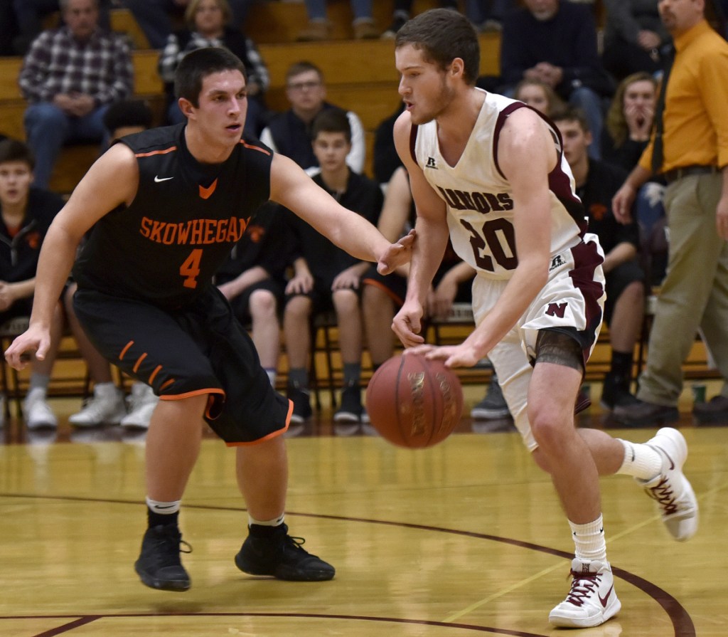 Nokomis senior guard Zach Hartsgrove dribbles past Skowhegan defender Marcus Christopher during a Kennebec Valley Athletic Conference Class A game earlier this season in Newport.