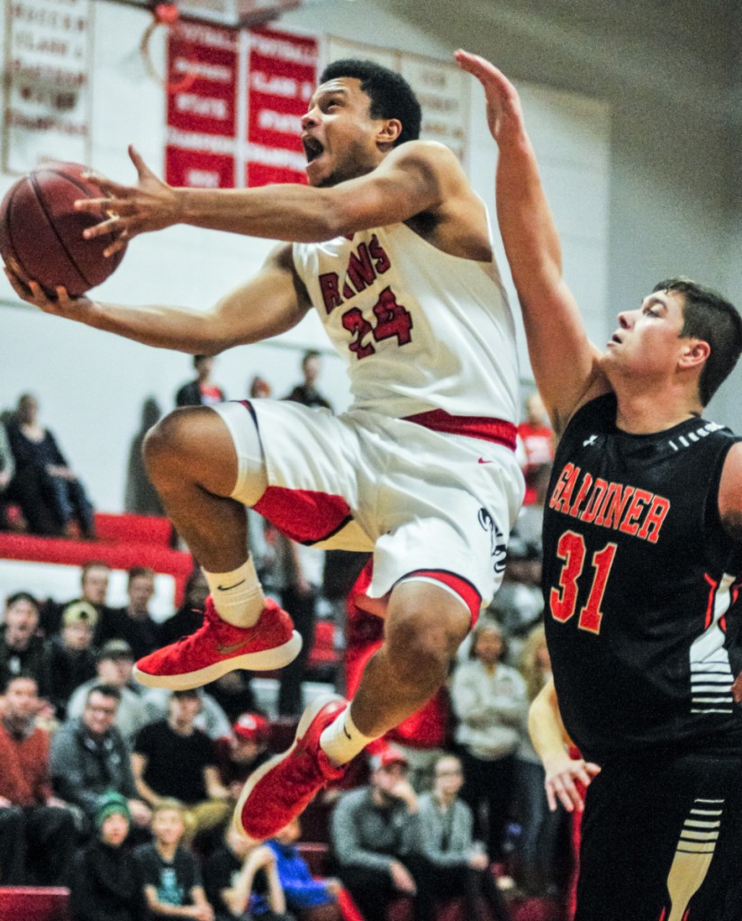 Cony's Jordan Roddy, left, goes up for a shot as Gardiner's Ben Shaw defends during a game earlier this season at Cony High School in Augusta.