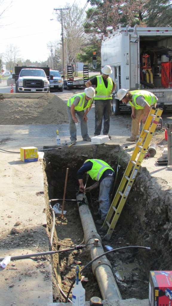 Employees from ETTI, a utilities construction company, replace an electrofusion tee on a Summit Natural Gas line in May 2015 in Waterville. An electrofusion tee is a piece of equipment that connects individual service lines to the gas main. Many of them were installed incorrectly by contractors hired by Summit but were replaced within days by the company.