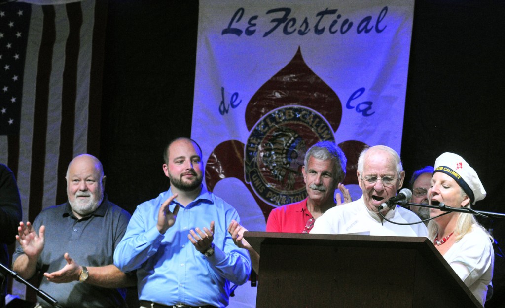 Larry Guimond and Rachel Boucher Ellis lead the singing of Le Club Calumet's anthem July 8, 2016, during the opening night of Le Festival de La Bastille in Augusta.