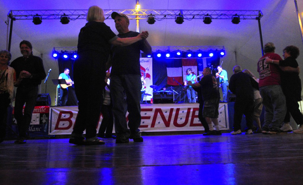 People dance in the main tent on July 8, 2016, during the opening night of Le Festival de La Bastille in Augusta.