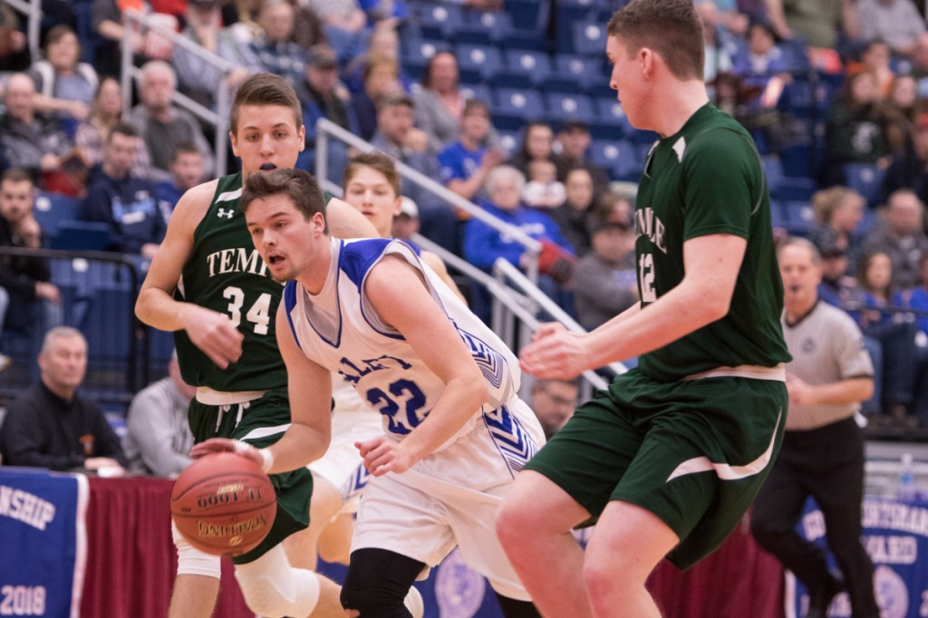 Valley senior Dillon Beane drives to the basket past Temple defenders llija Lvkovic and Nicholas Blaisdell during a Class D South quarterfinal game Saturday at the Augusta Civic Center.
