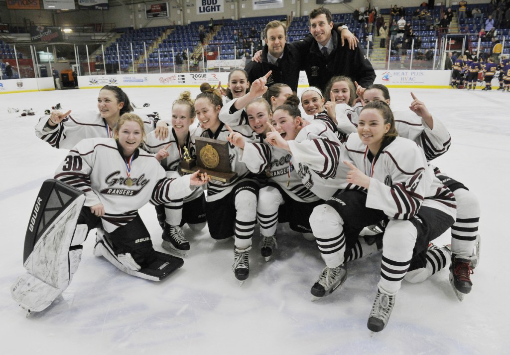 Members of the Greely/Gray-New Gloucester girls hockey team celebrate after they won the girls hockey state championship Saturday in Lewiston.