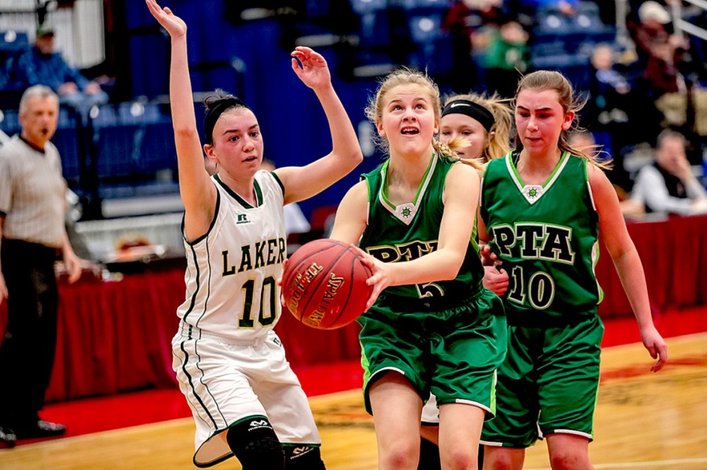 Pine Tree Academy's Emily Schlisner goes to the basket as Rangeley's Brooke Egan looks to defend during a Class D South quarterfinal game Monday at the Augusta Civic Center.
