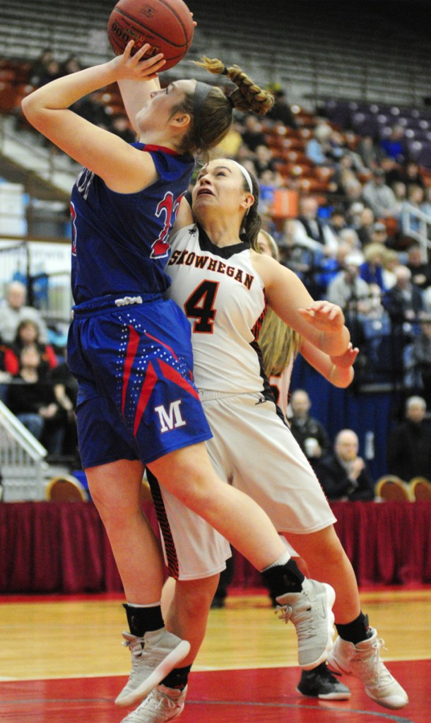 Messalonskee freshman Brooke Martin shoots as Skowhegan captain Lindsey Warren defends during a Class A North semifinal game Wednesday at the Augusta Civic Center.