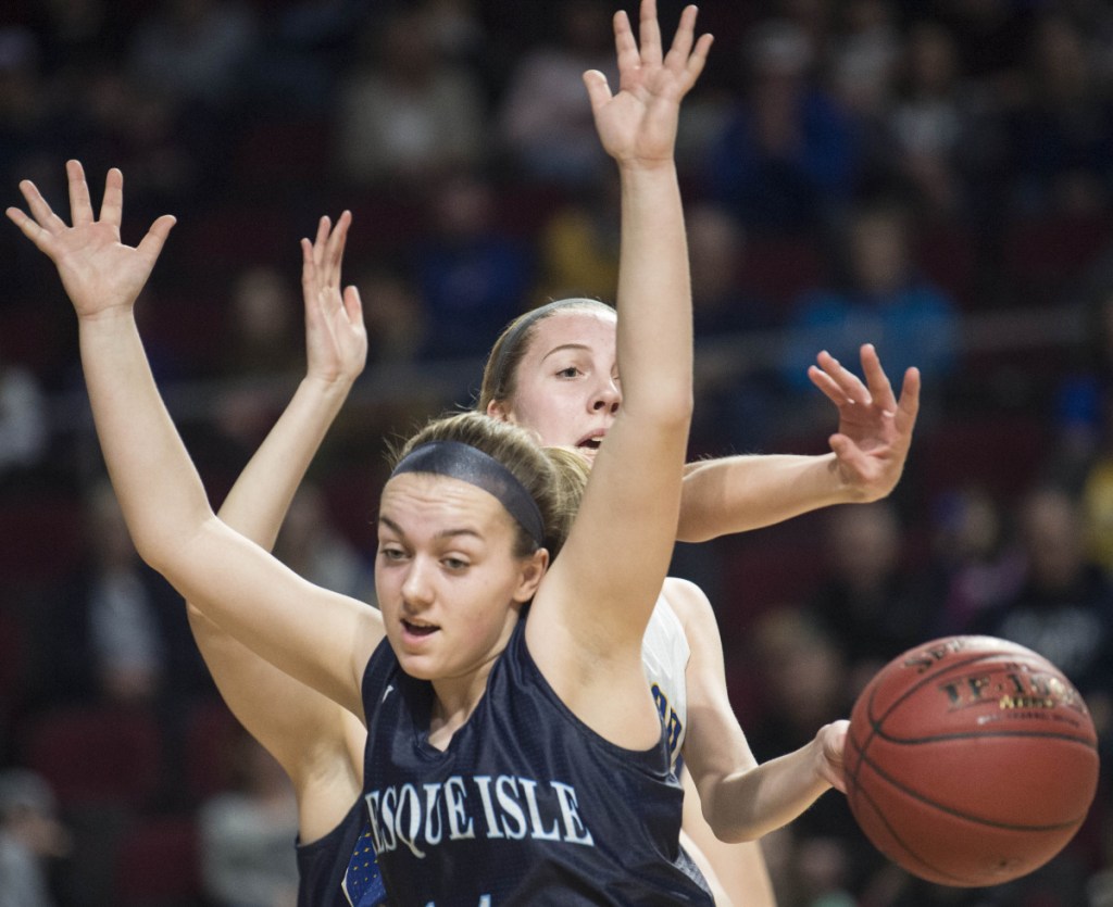 Hermon's Lauren Plissey, back, battles for a rebound with Presque Isle's Emily Wheaton during a Class B North semifinal Wednesday afternoon at the Cross Insurance Center in Bangor.