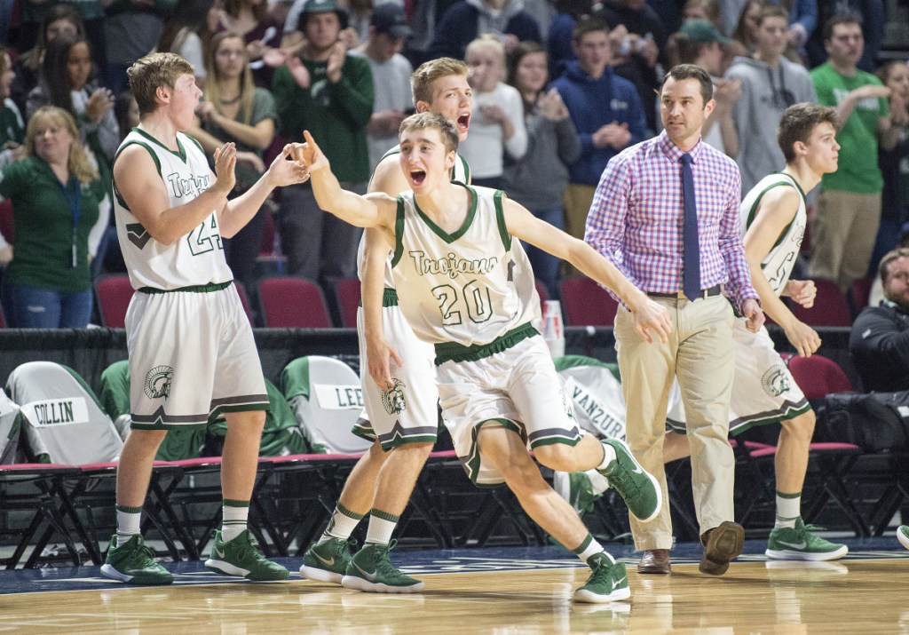 Mount Desert Island's Brett Duley celebrates with teammates after they took the lead over Presque Isle during a Class B North semifinal Wednesday at the Cross Insurance Center in Bangor.