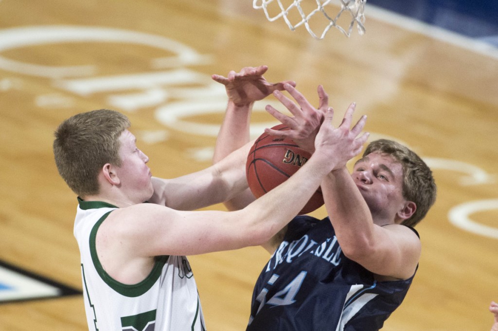 Mount Desert Island's Andrew Shea, left, battles for a rebound with Presque Isle's Trace Cyr during a Class B North semifinal Wednesday at the Cross Insurance Center in Bangor.