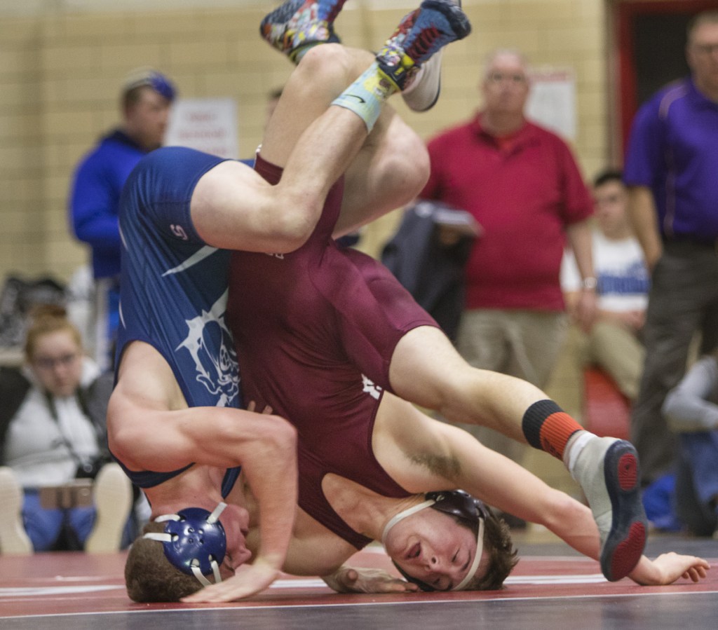 Portland's Zackary Elowitch and Nokomis'Quinton Richards roll on their heads during the 152 lb. match during the Class A state wrestling championships last weekend in Sanford. Richards will compete Saturday at the New England Qualifier at Nokomis High School in Newport.
