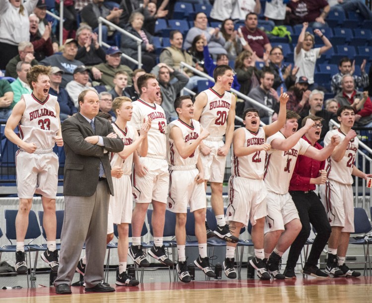 The Hall-Dale High School basketball team celebrates a 3-pointer during a Class C South semifinal game against Richmond on Thursday at the Augusta Civic Center.