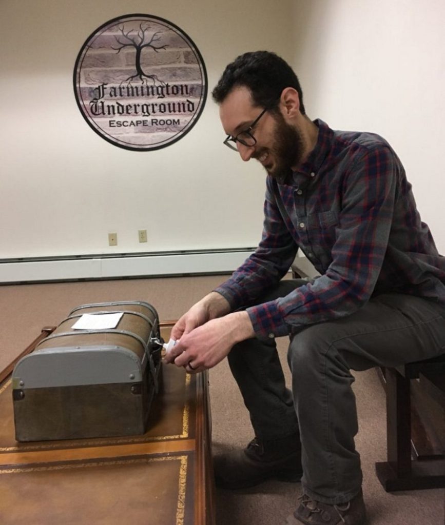 Joe Musumeci, owner and operator of Farmington Underground, demonstrates the introductory puzzle chest, the first challenge for participants at his escape room business at 109 Church St. in Farmington.